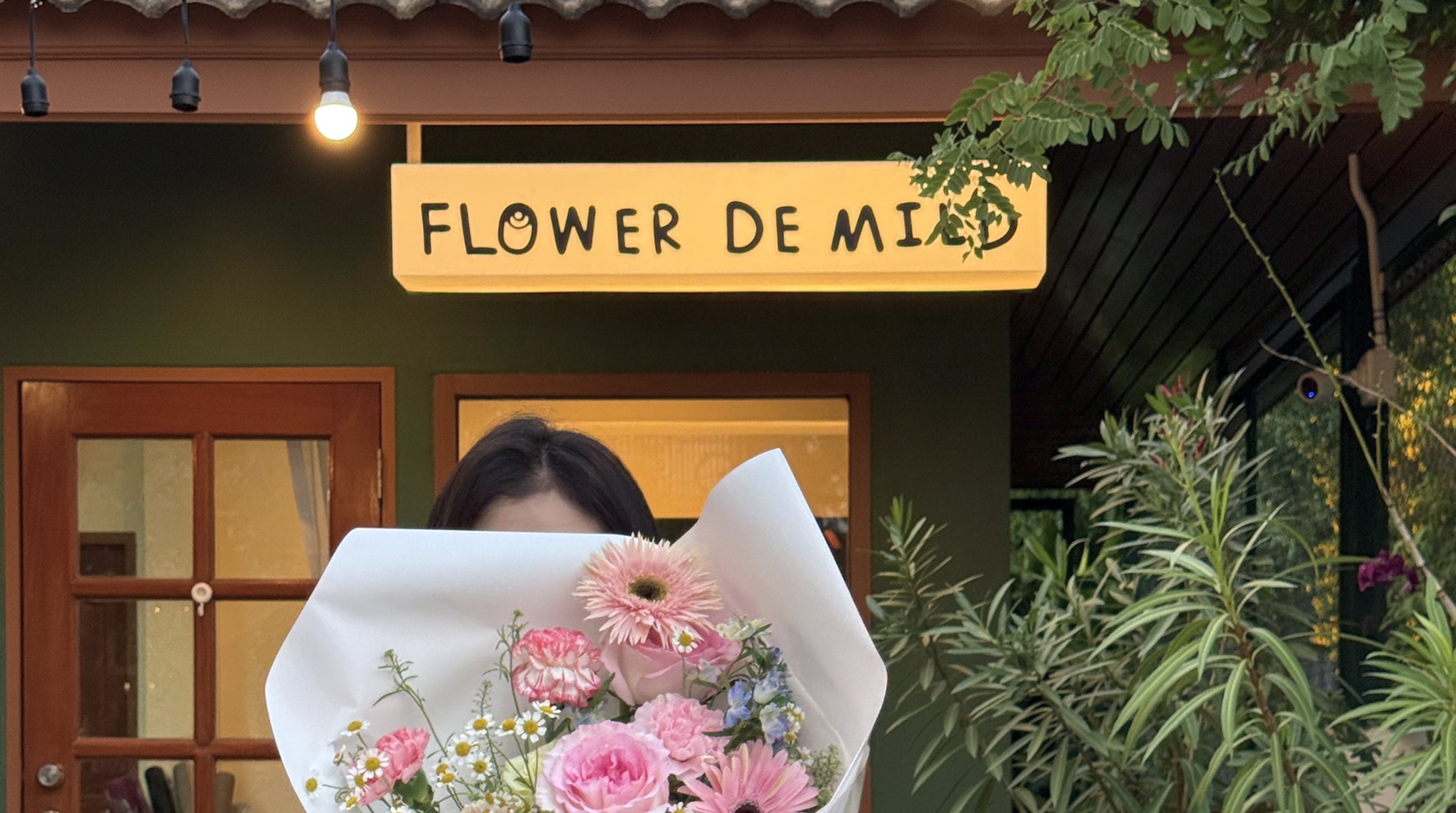 The Flower De Mild shop, a blush plaster room full of buckets of flowers